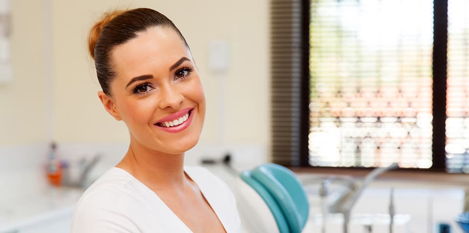 A young woman smiling in the dental office
