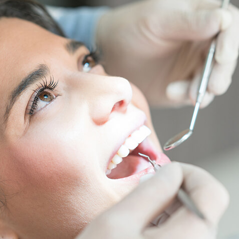 A close-up female patient getting a dental procedure